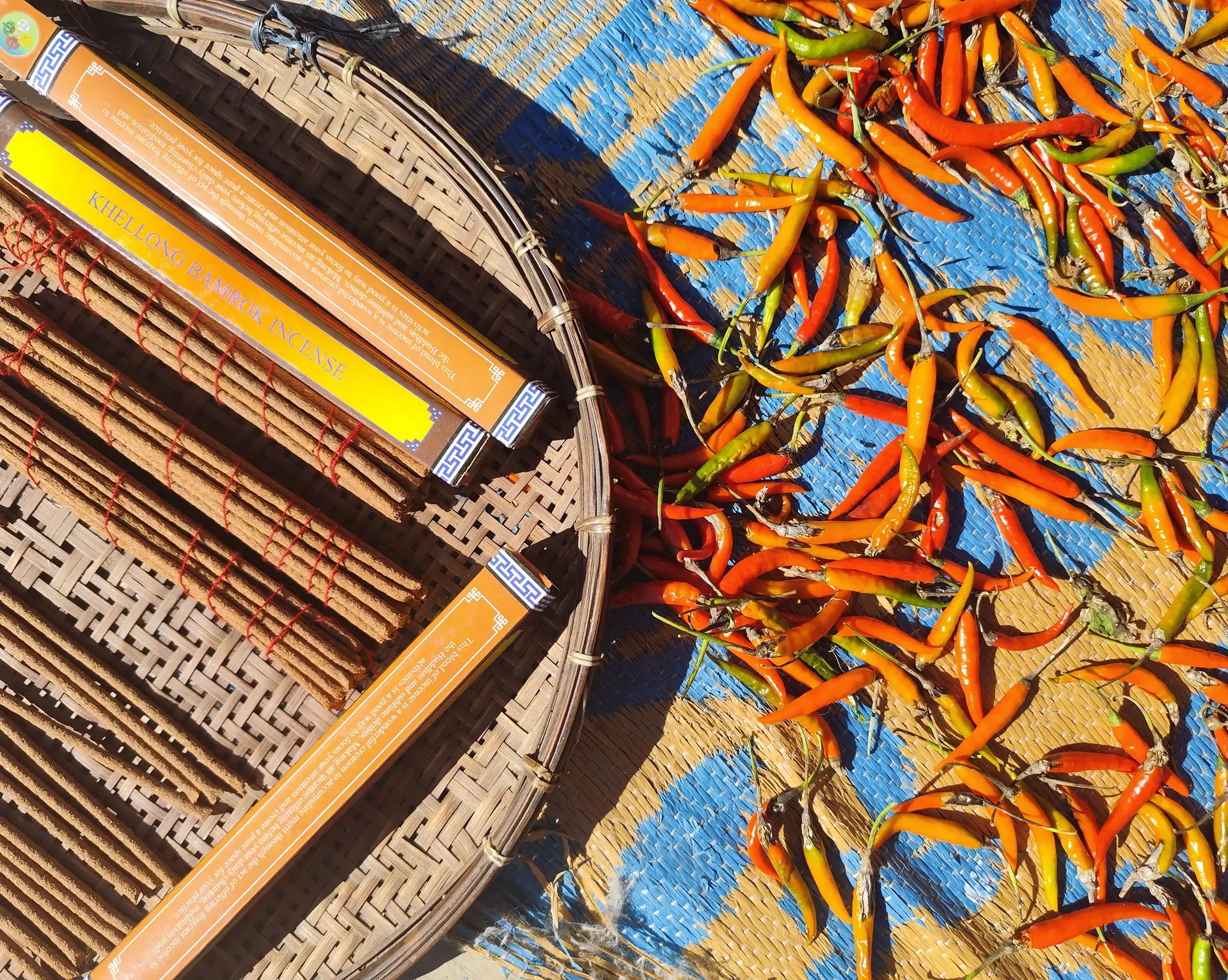 Travel in Asia - Chili peppers drying in the sun next to a basket