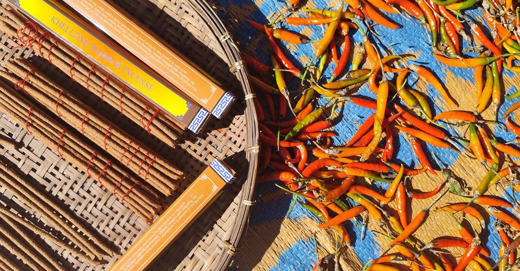 Travel in Asia - Chili peppers drying in the sun next to a basket