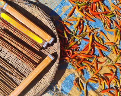 Travel in Asia - Chili peppers drying in the sun next to a basket