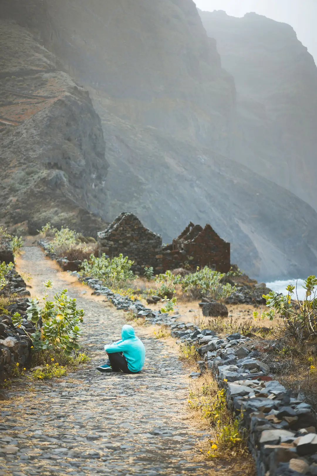 traveler-in-hoodie-sitting-in-aranhas-valley-in-fr-2024-10-18-05-33-55-utc.jpg