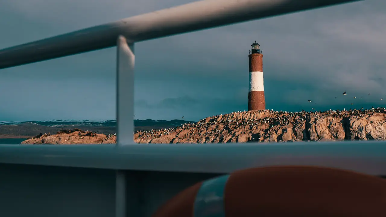 Voyage en Argentine – Le célèbre phare rouge et blanc Les Éclaireurs sur son îlot rocheux dans le canal de Beagle à Ushuaia.