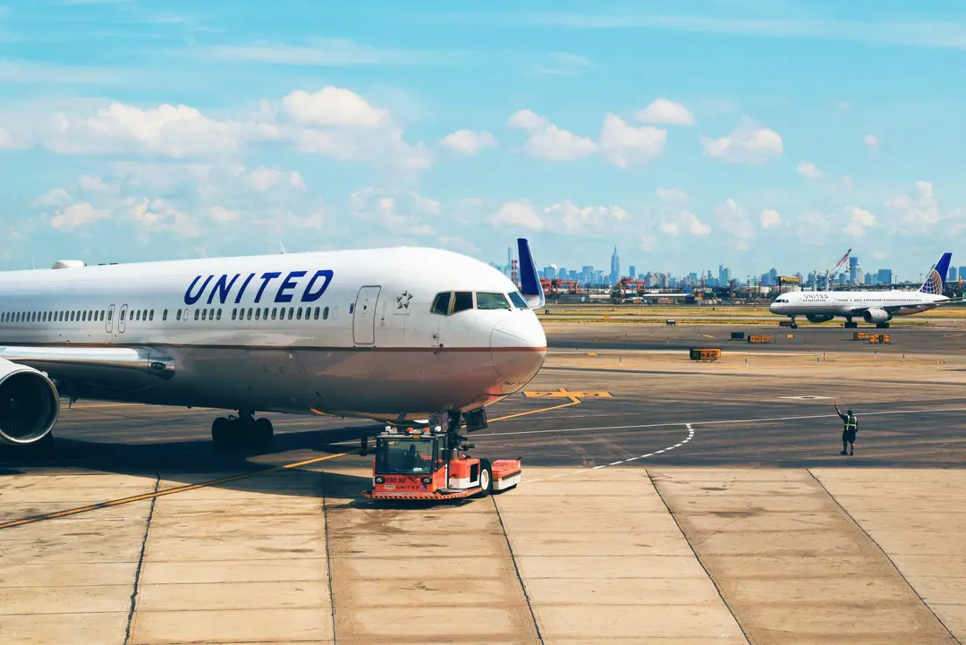 Avion sur la piste à l'aéroport de Newark avec la ligne d'horizon de la ville en arrière-plan