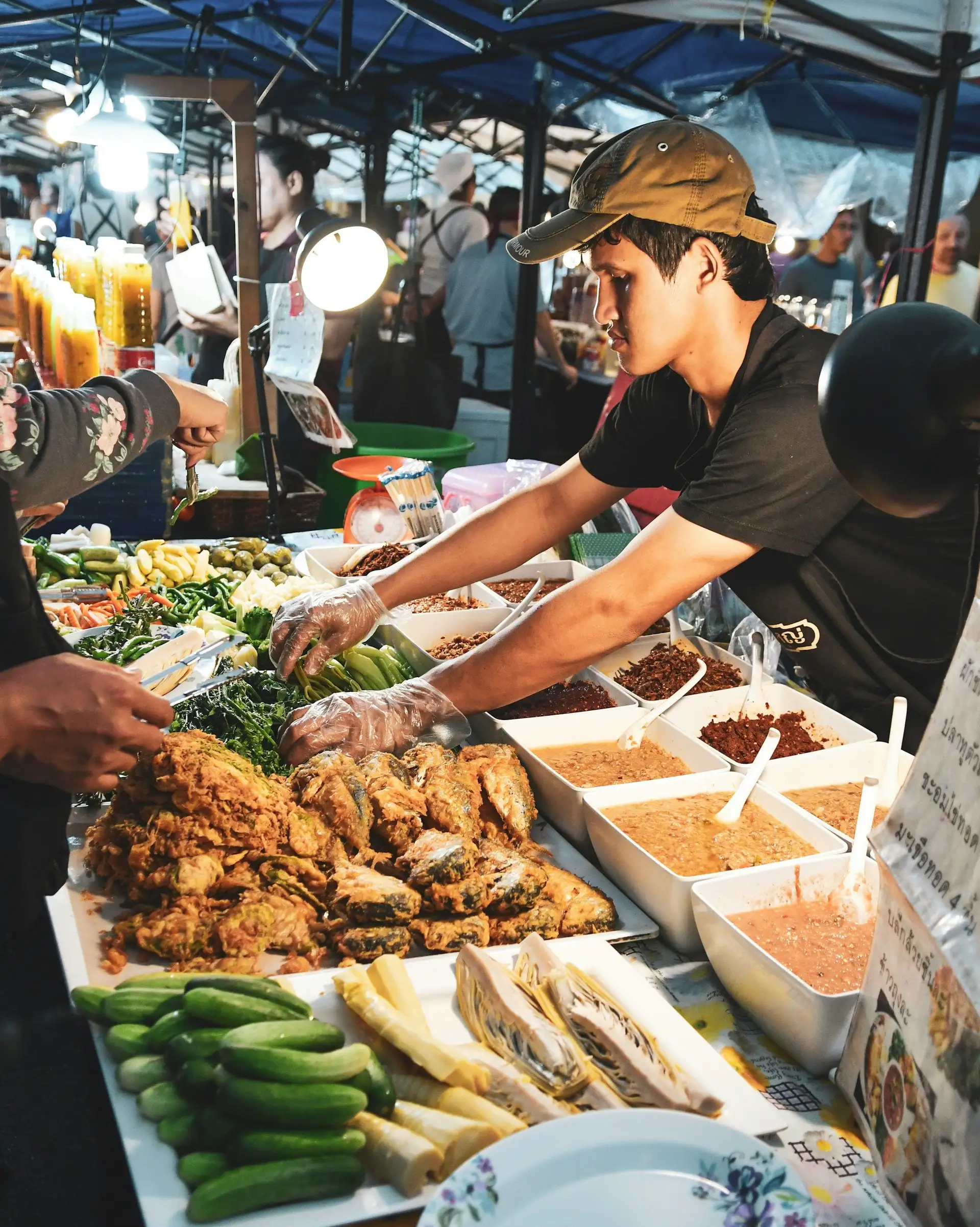 Travel in Asia - Vendor arranging food at a night market stall in Bali
