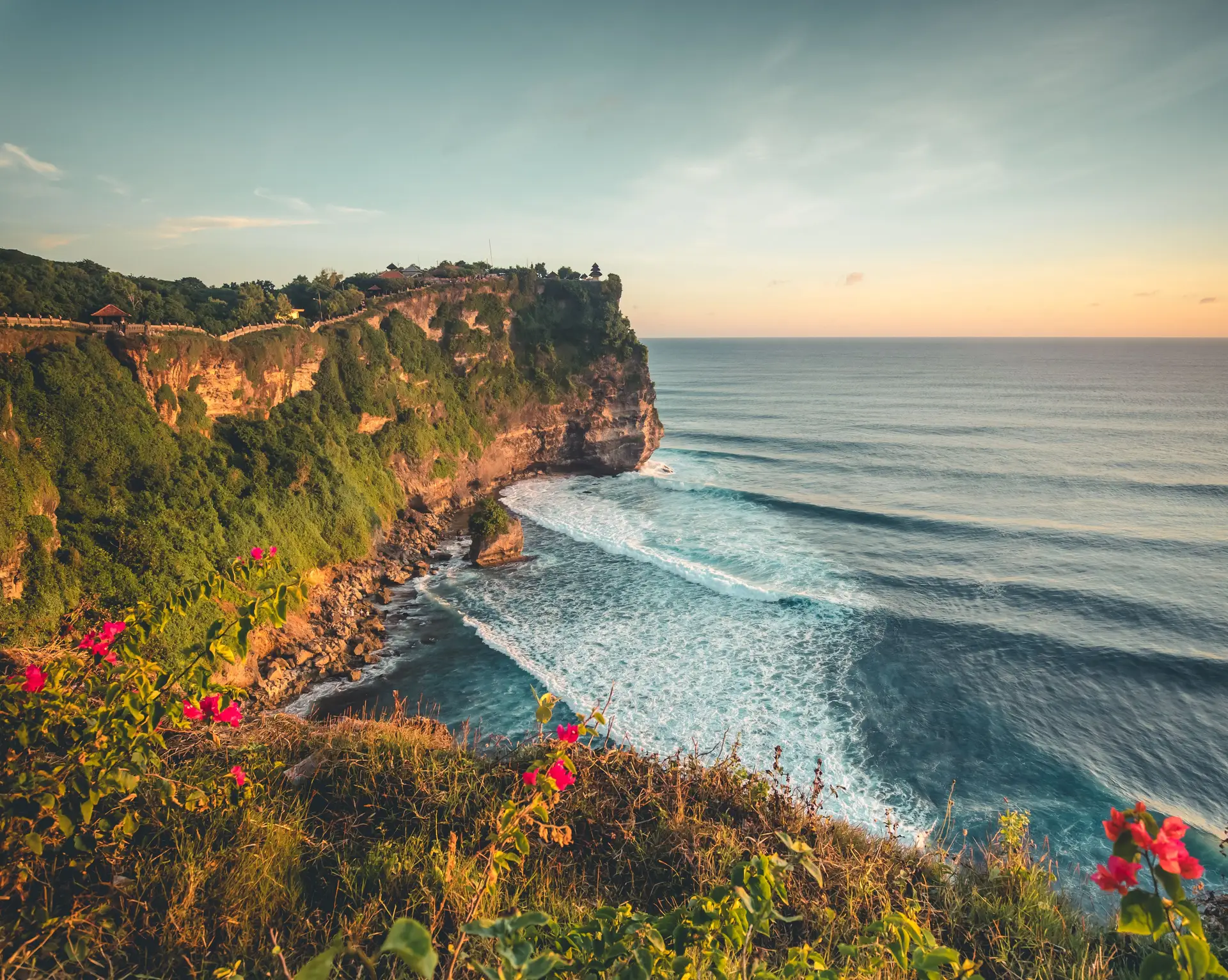 Travel in Asia - Sunset over the Indian Ocean from the cliffs of the Uluwatu Temple (Pura Luhur Uluwatu) in Bali, Indonesia