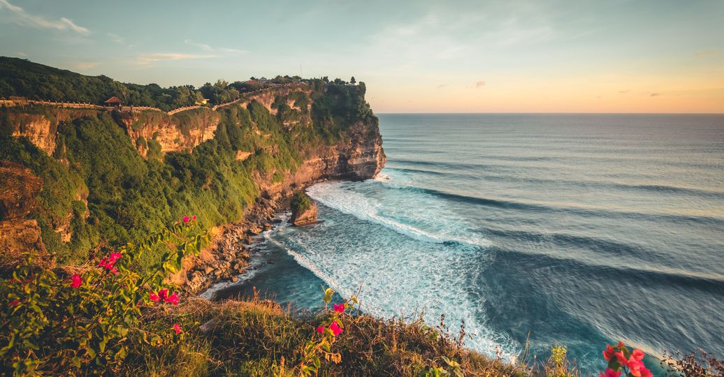 Travel in Asia - Sunset over the Indian Ocean from the cliffs of the Uluwatu Temple (Pura Luhur Uluwatu) in Bali, Indonesia