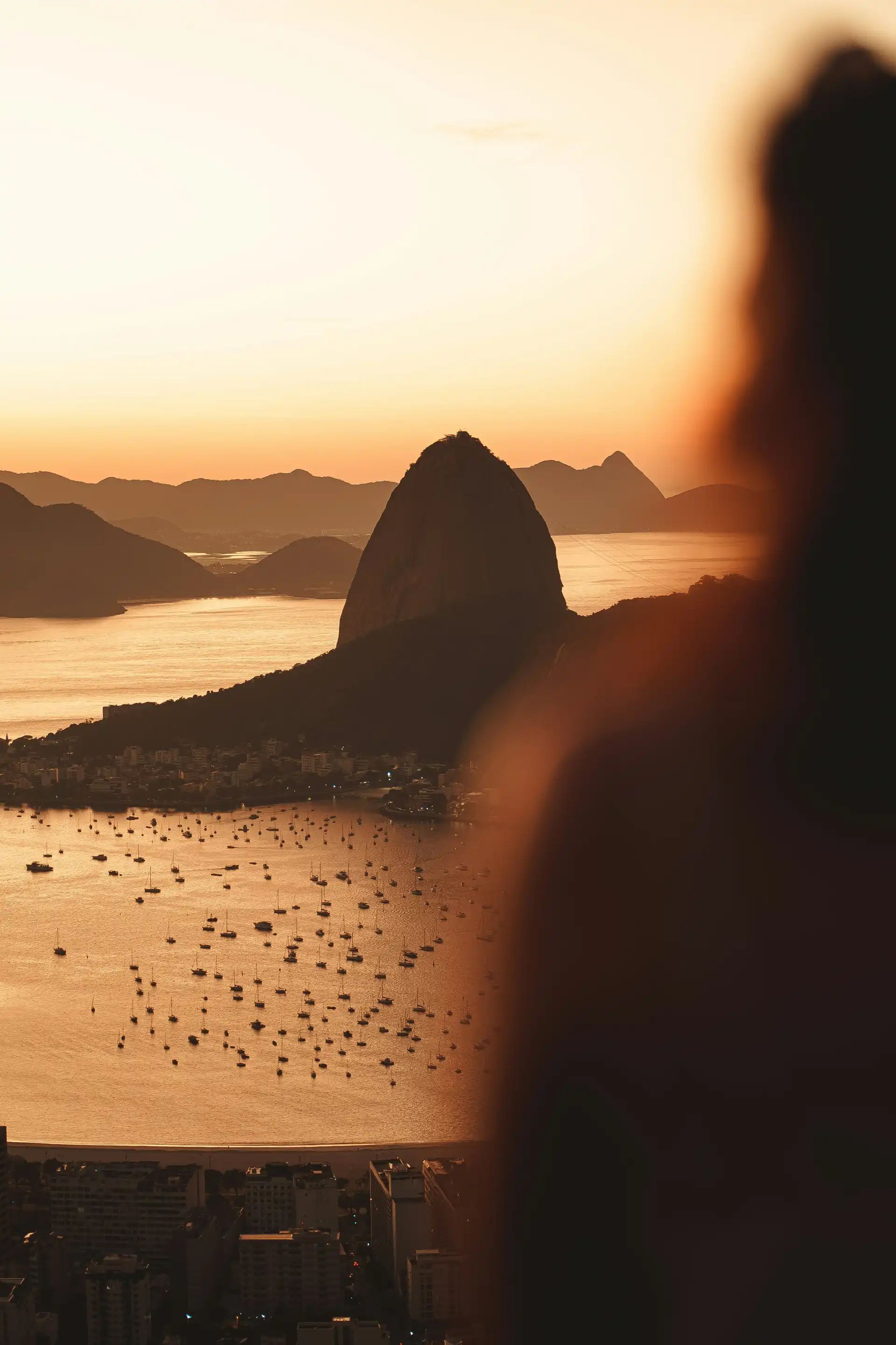 Voyage au Brésil – La silhouette du mont Pain de Sucre se découpant sur un ciel doré au coucher du soleil au-dessus de la baie de Rio de Janeiro.