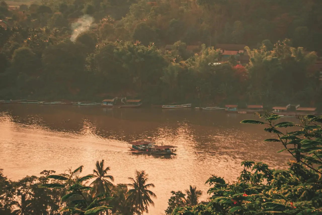 Voyage au Cambodge : Bateau dans le coucher du soleil du Mékong