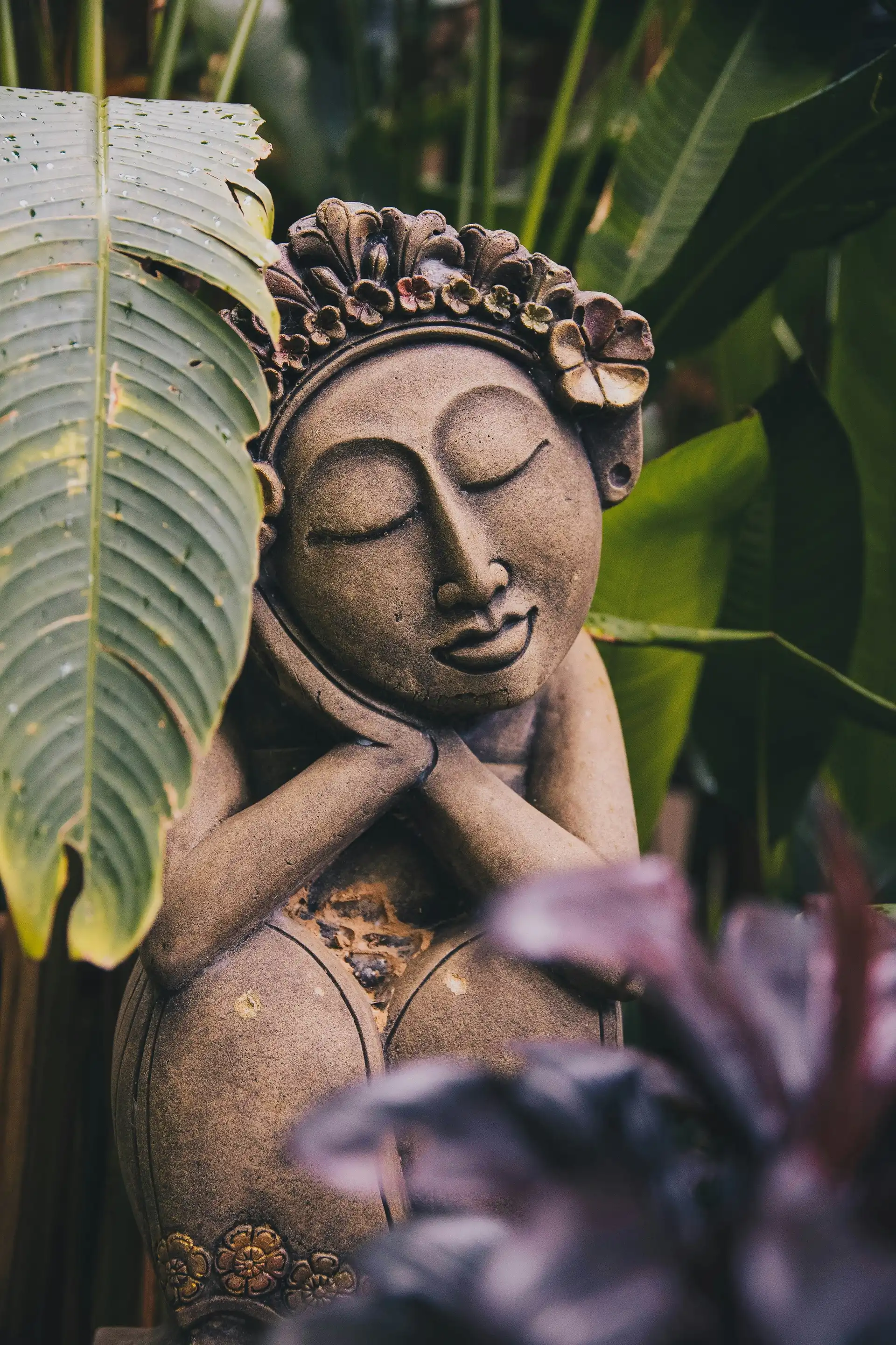 Travel in Asia - A small garden statue of a woman resting