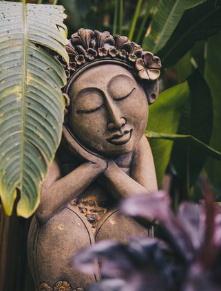 Travel in Asia - A small garden statue of a woman resting
