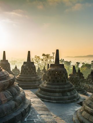 Travel in Asia - Sunset over the stupas at Borobudur temple on the island of Java in Indonesia