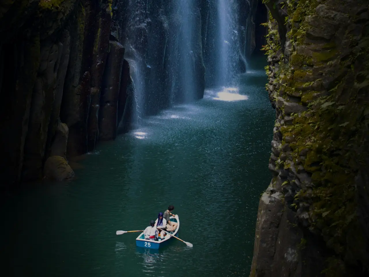 stunning view of manai waterfall cascading into the turquoise river inside the narrow basalt columns of takachiho gorge in kyushu