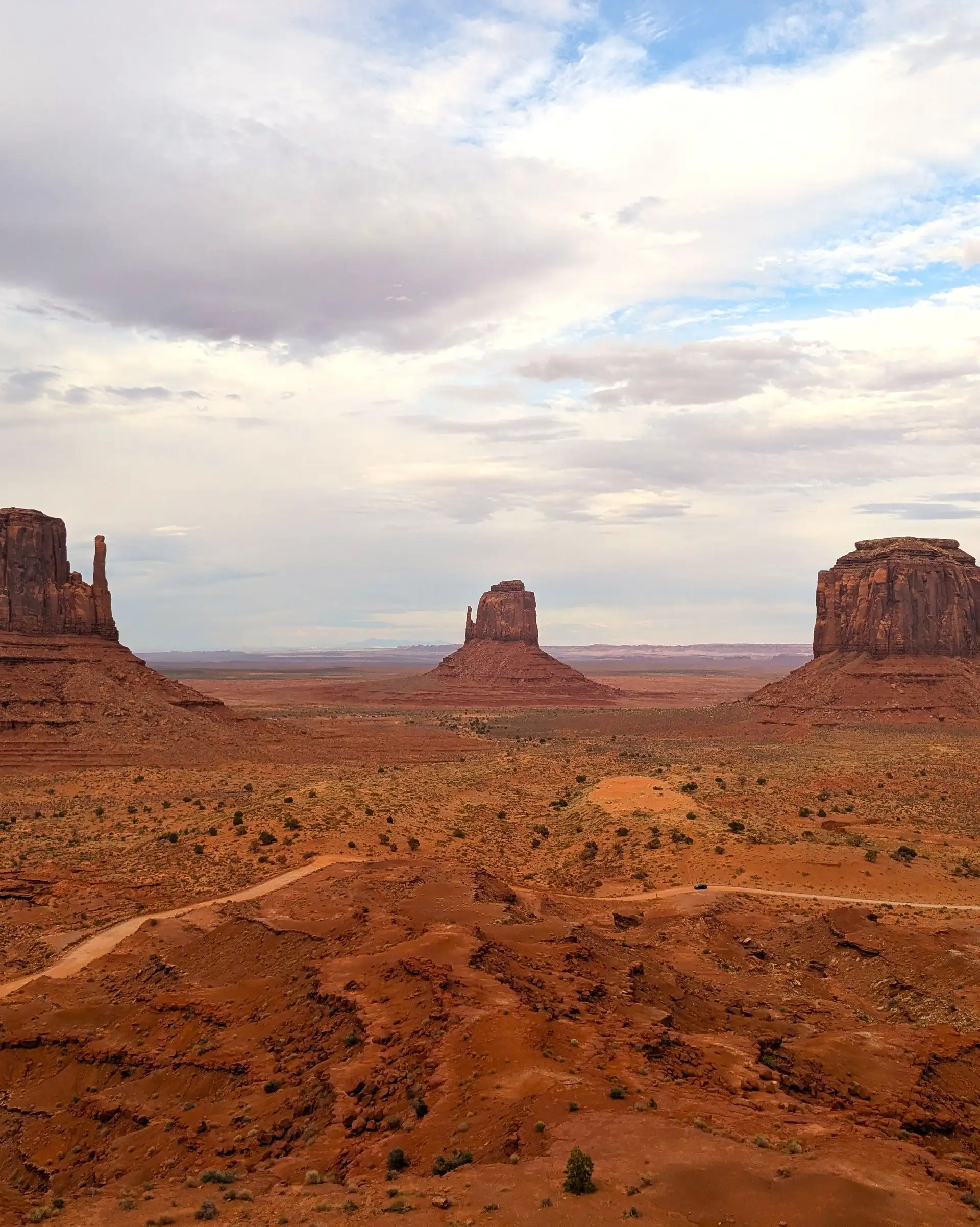 Panorama désertique sur les célèbres buttes de grès rouge de Monument Valley sous un ciel nuageux