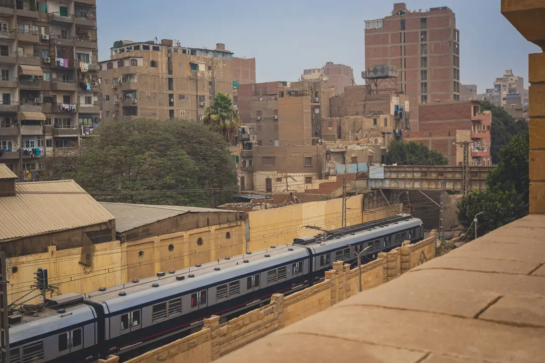 Une vue animée du Caire avec un train au milieu d'une architecture urbaine dense