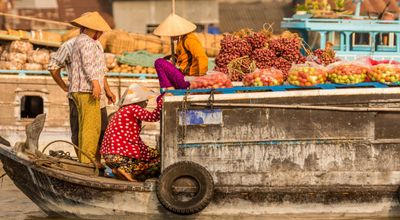 Travel in Asia - People at a floating market on a boat in Vietnam