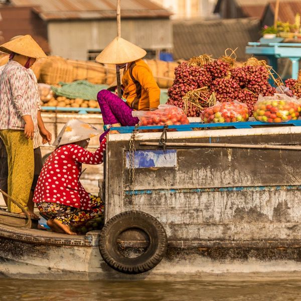 Travel in Asia - People at a floating market on a boat in Vietnam