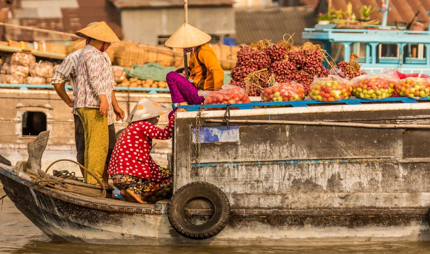 Travel in Asia - People at a floating market on a boat in Vietnam