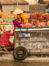 Travel in Asia - People at a floating market on a boat in Vietnam