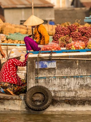 Travel in Asia - People at a floating market on a boat in Vietnam