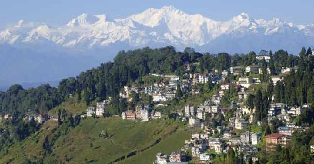 Travel in Asia - Aerial view of the town of Darjeeling with the snow-capped Kangchenjunga mountain range in the background