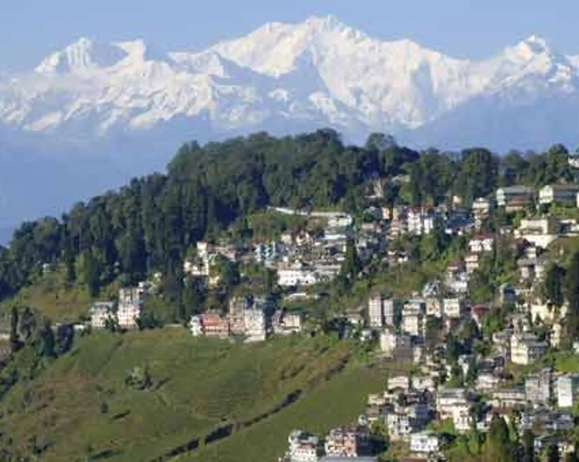 Travel in Asia - Aerial view of the town of Darjeeling with the snow-capped Kangchenjunga mountain range in the background