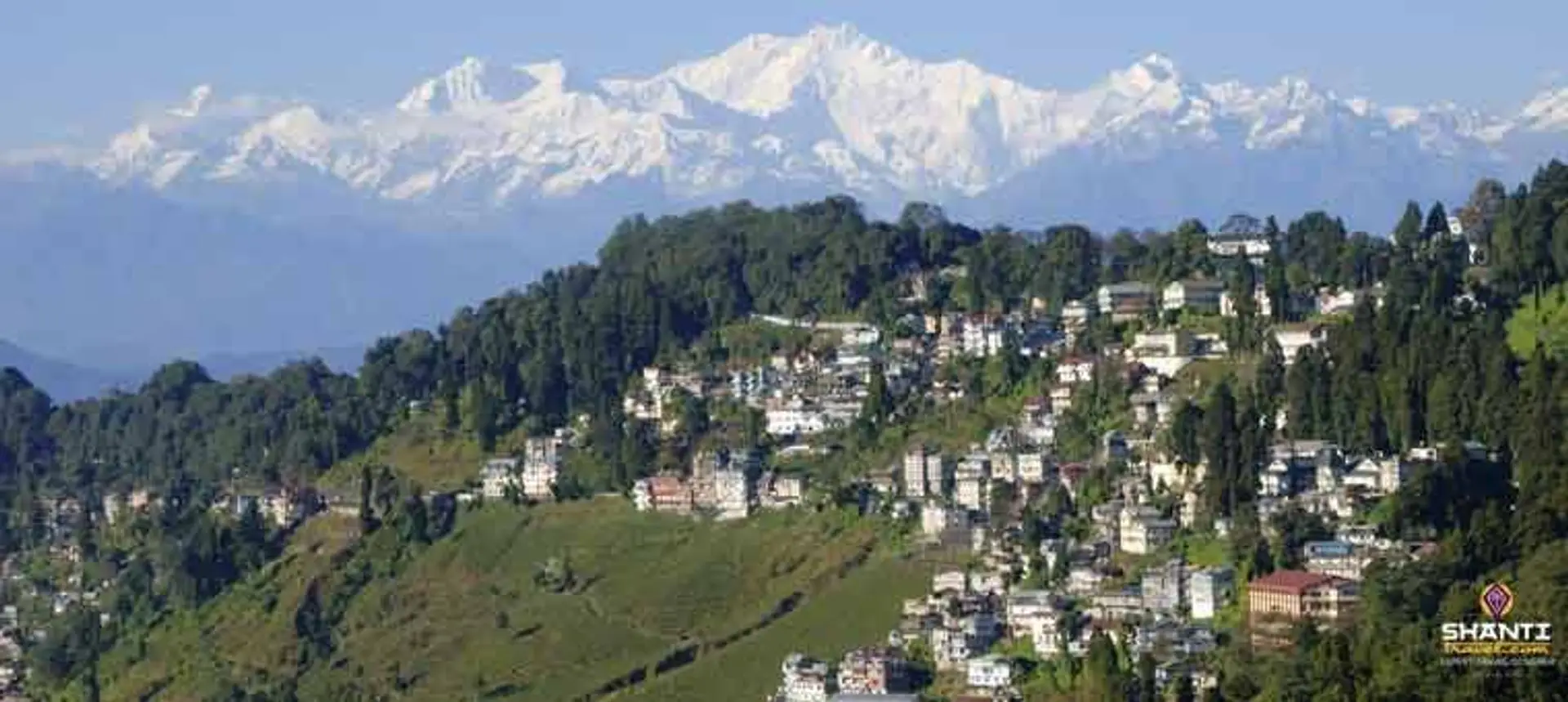 Travel in Asia - Aerial view of the town of Darjeeling with the snow-capped Kangchenjunga mountain range in the background