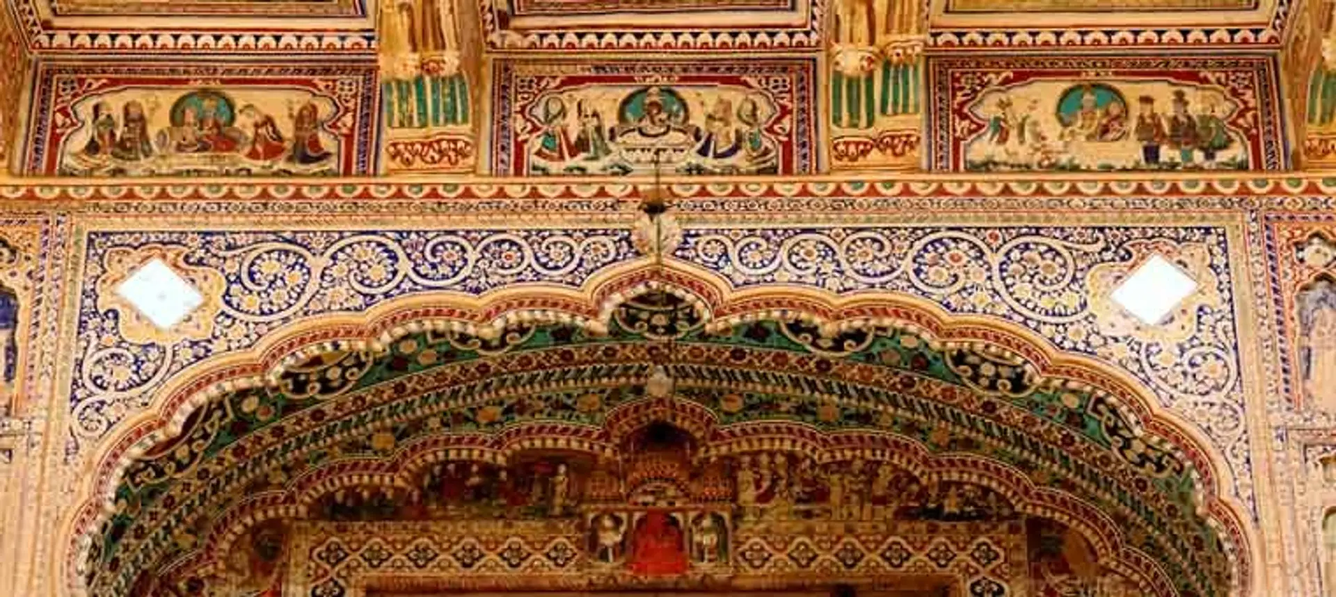 Travel in Asia - Richly decorated archway and upper frieze in a frescoed haveli in the Shekhawati region of Rajasthan, India