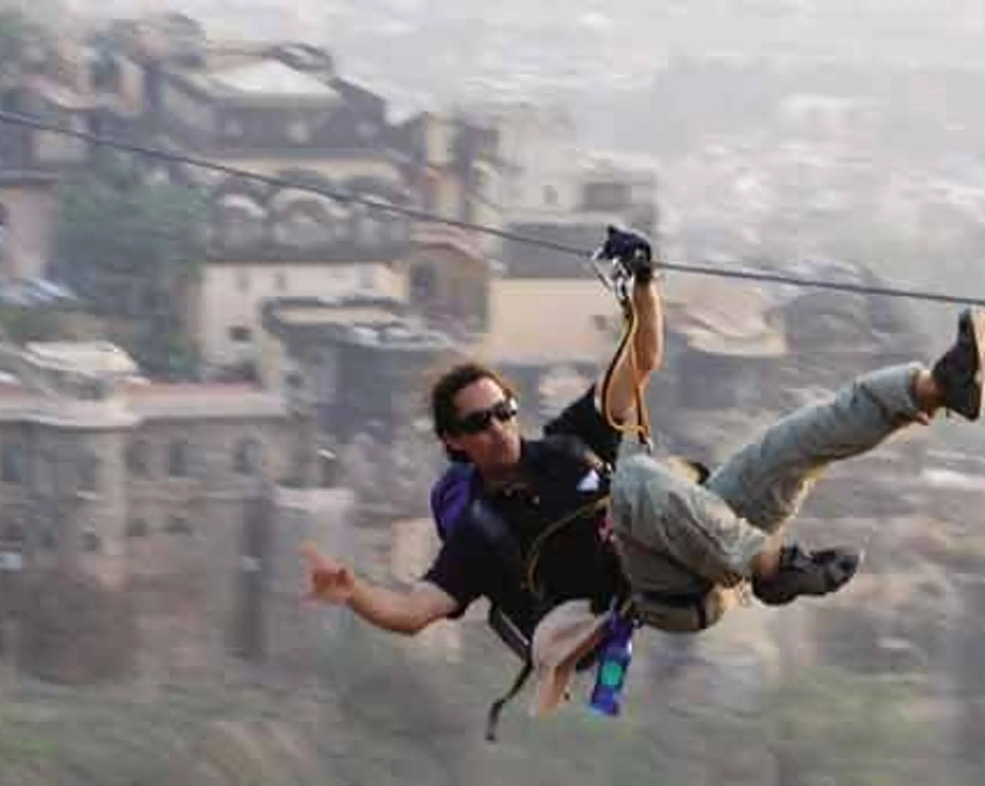 Travel in Asia - Man ziplining at the Neemrana at the Fort Palace in Rajasthan, India