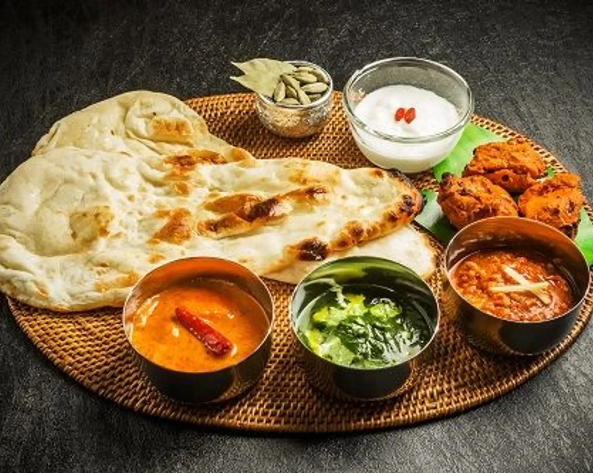 Travel in Asia - A spread of Indian cuisine, including curries, naan bread, and sides