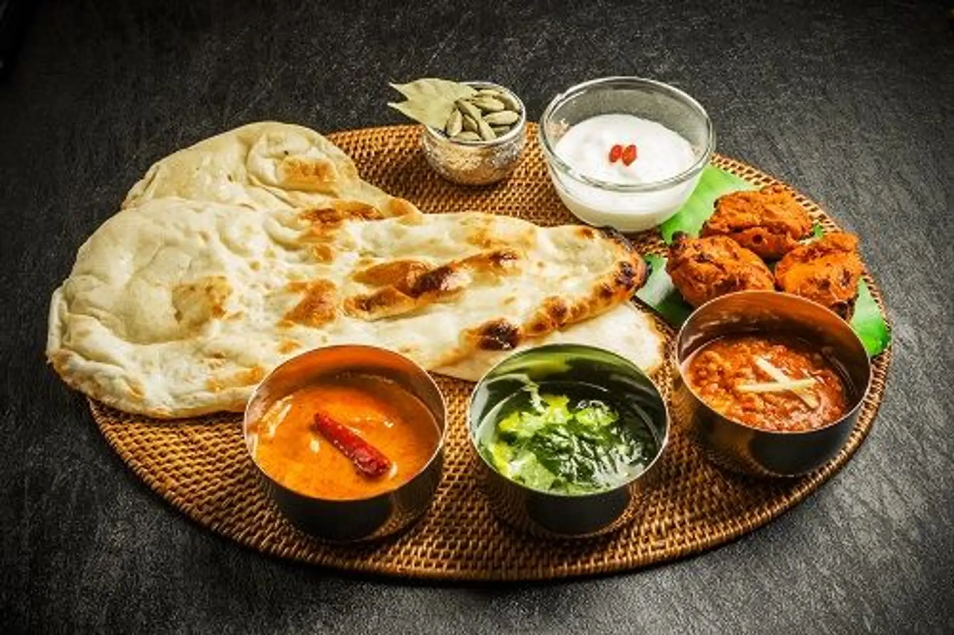 Travel in Asia - A spread of Indian cuisine, including curries, naan bread, and sides