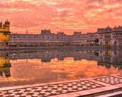 Travel in Asia - Man walking around the lake of the Harmandir Sahib, or Golden Temple, in Amritsar, Punjab, India