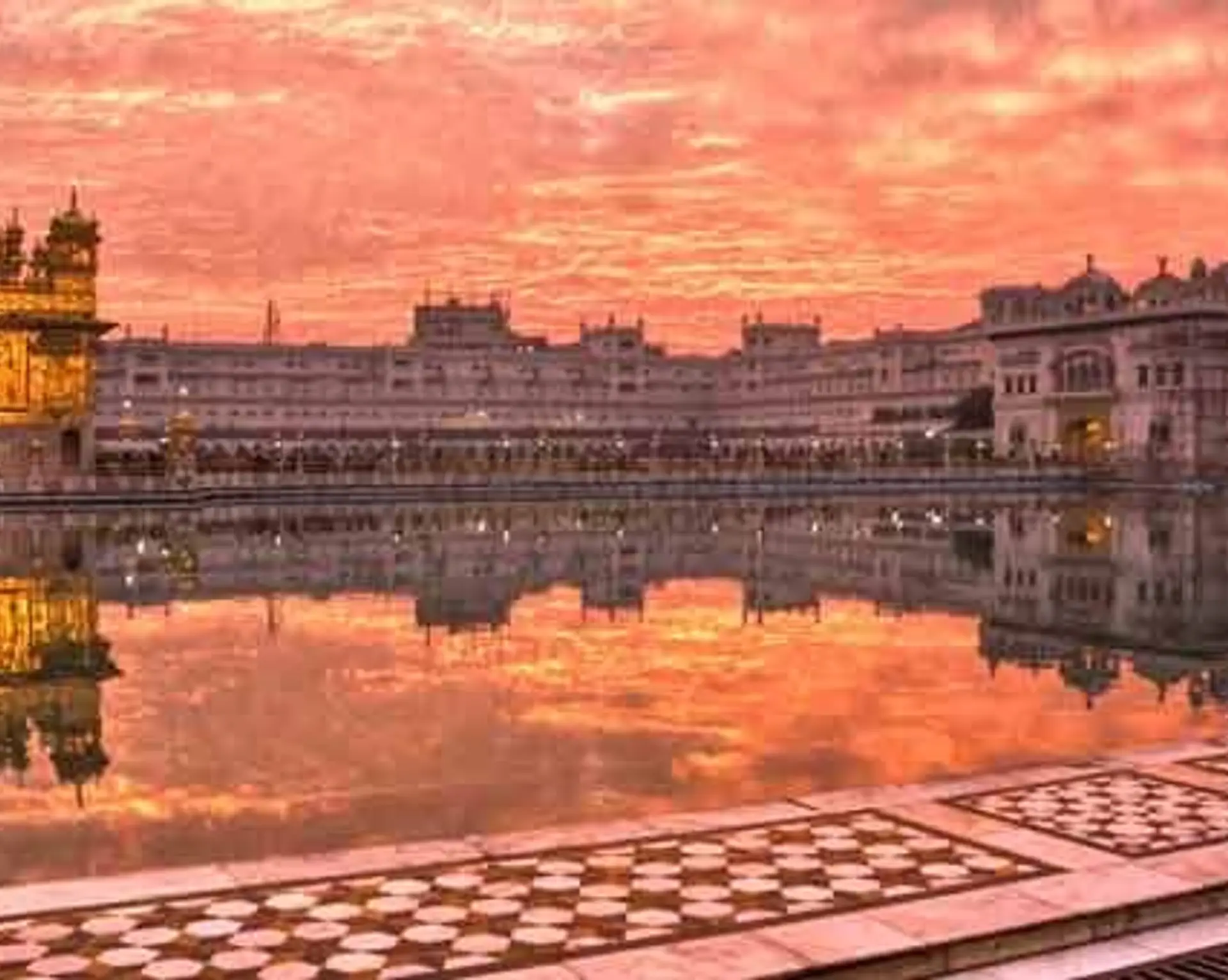 Travel in Asia - Man walking around the lake of the Harmandir Sahib, or Golden Temple, in Amritsar, Punjab, India