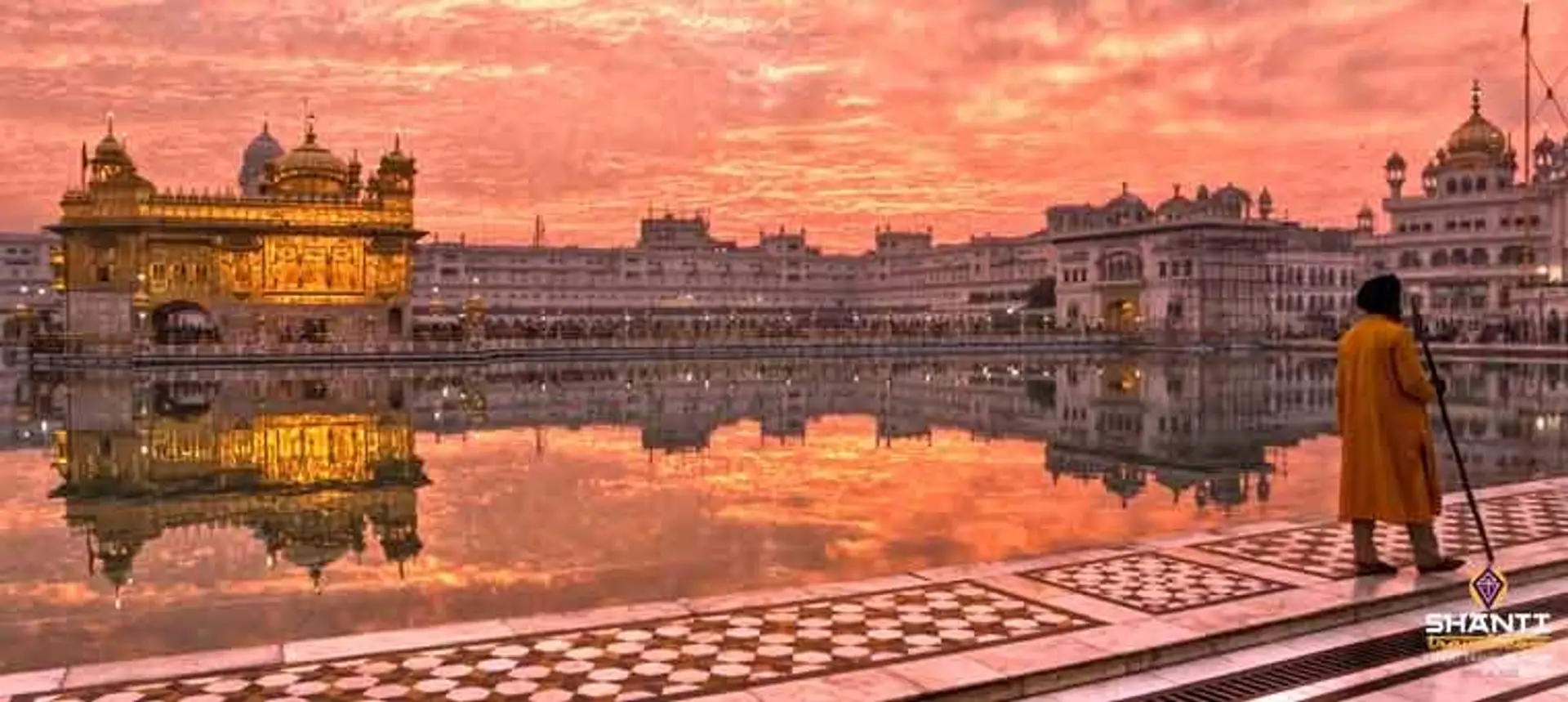 Travel in Asia - Man walking around the lake of the Harmandir Sahib, or Golden Temple, in Amritsar, Punjab, India