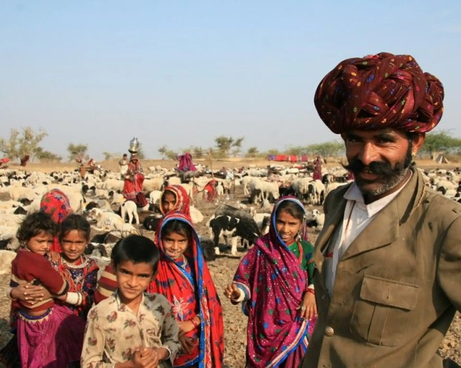 Travel in Asia - A man in a turban and other people at the Pushkar Fair in Rajasthan, India
