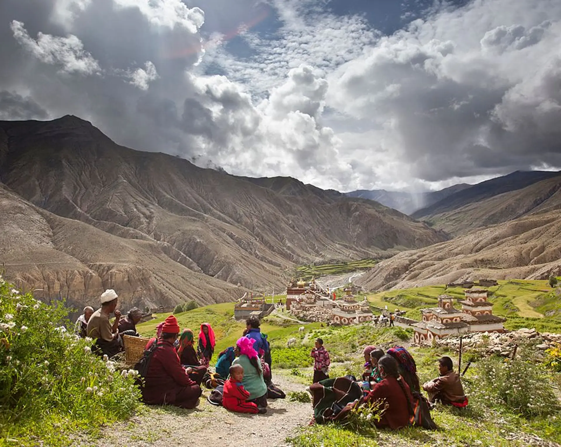 Travel in Asia - People resting on a trail above a village in the Dolpo region of Nepal