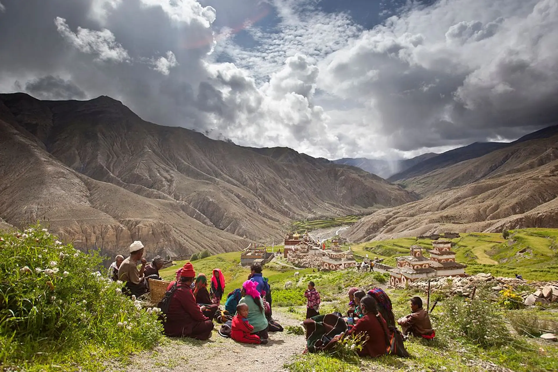 Travel in Asia - People resting on a trail above a village in the Dolpo region of Nepal