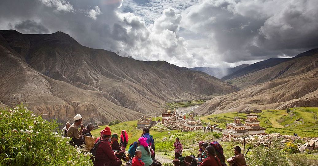 Travel in Asia - People resting on a trail above a village in the Dolpo region of Nepal