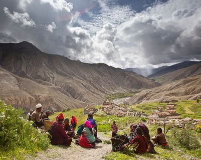 Travel in Asia - People resting on a trail above a village in the Dolpo region of Nepal