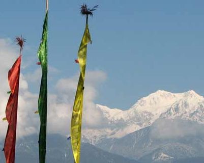 Travel in Asia - Prayer flags fluttering in the wind with the Kanchenjunga range in the background