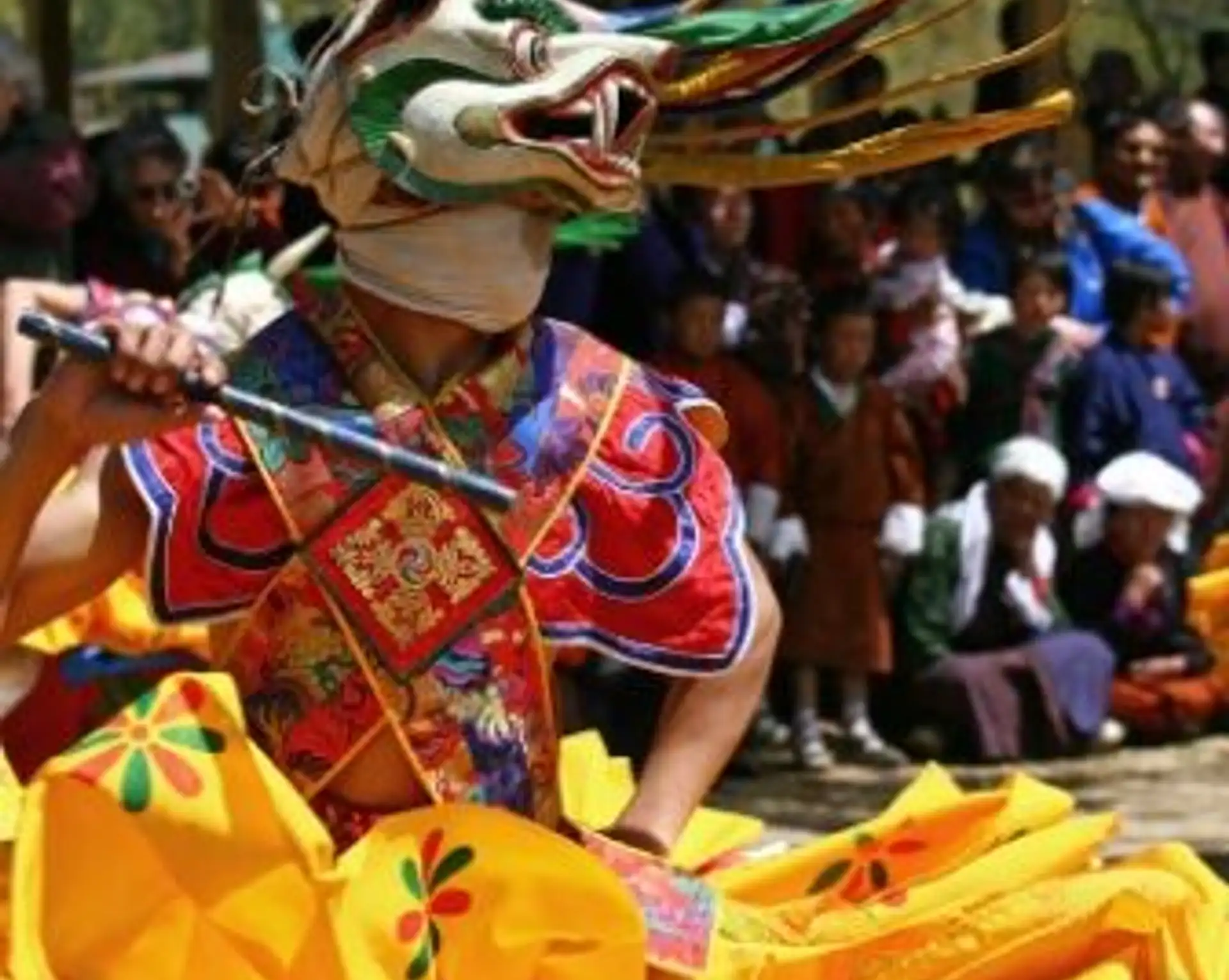 Travel in Asia - Dancer in a vibrant costume at the Tshechu festival in Bhutan