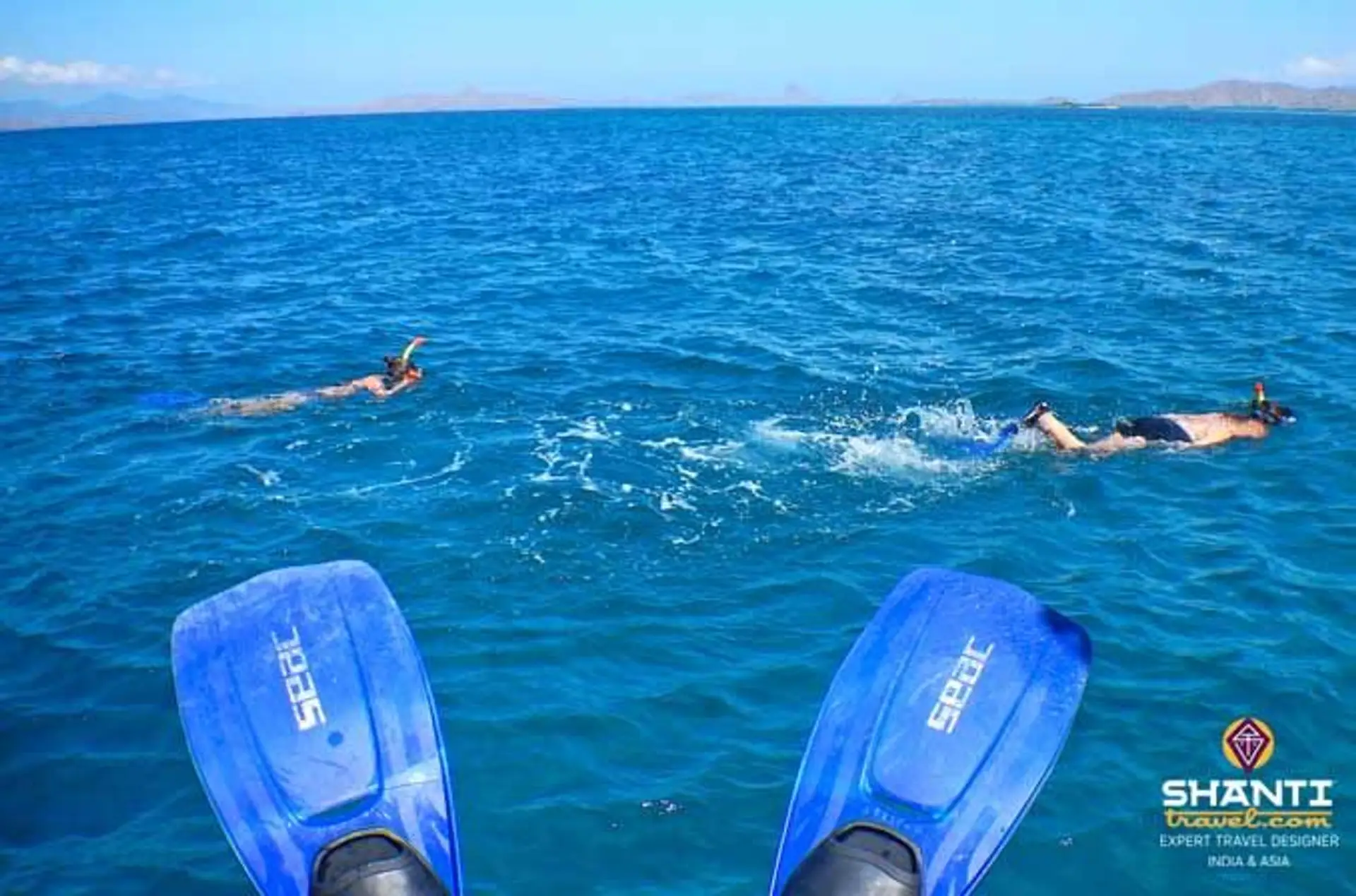 Travel in Asia - Person in flippers watching other snorkelers in the ocean