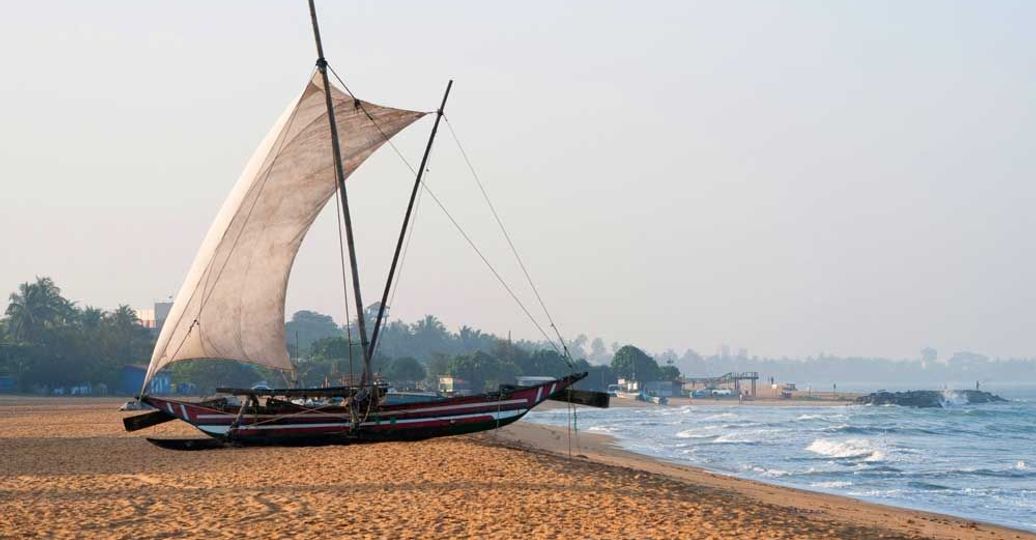 Travel in Asia - A Sri Lankan fishing boat, known as Oruwa, on the beach at Negombo, Sri Lanka