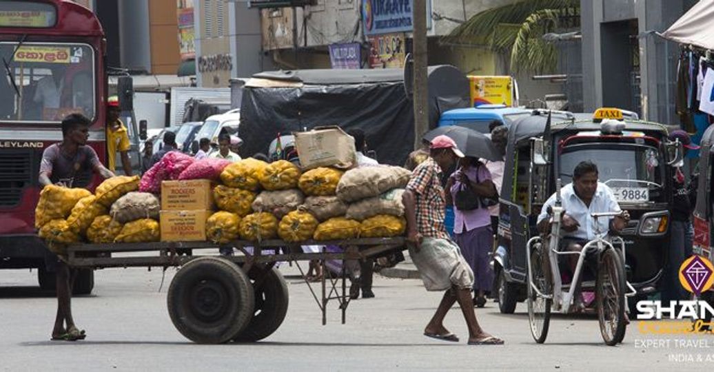 Travel in Asia - Street vendors and tuk tuk driver in the streets of the Pettah Market area of Colombo, Sri Lanka