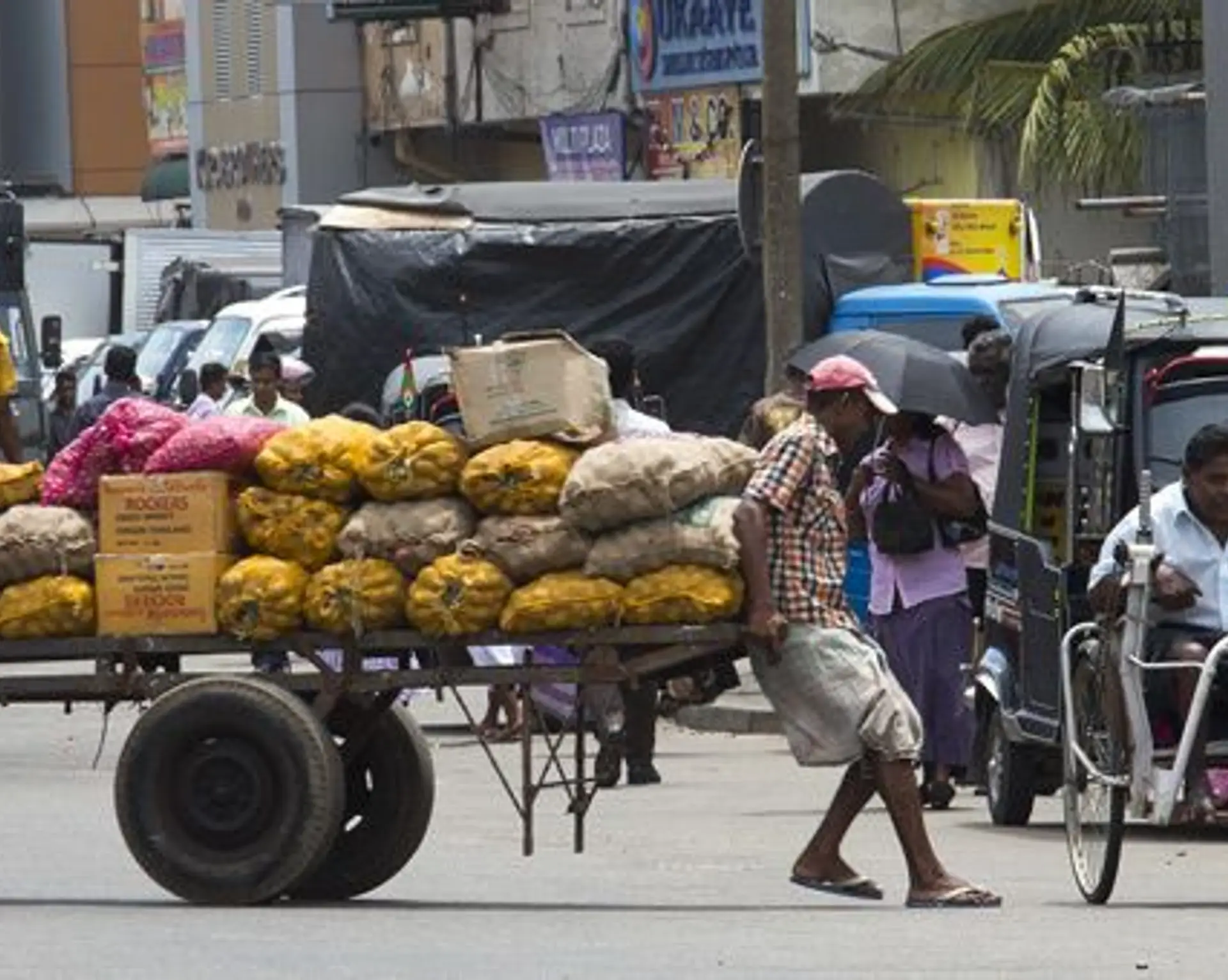 Travel in Asia - Street vendors and tuk tuk driver in the streets of the Pettah Market area of Colombo, Sri Lanka