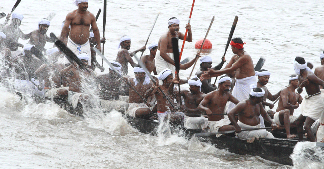 Travel in Asia - Men racing in the Vallam Kali Snake Boat Race in Kerala, India