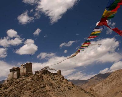 Travel in Asia - Prayer flags blowing in the wind at the Leh Palace in Ladakh, India