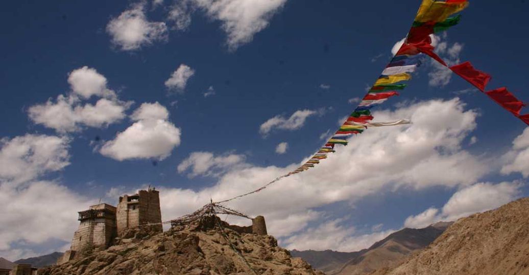 Travel in Asia - Prayer flags blowing in the wind at the Leh Palace in Ladakh, India
