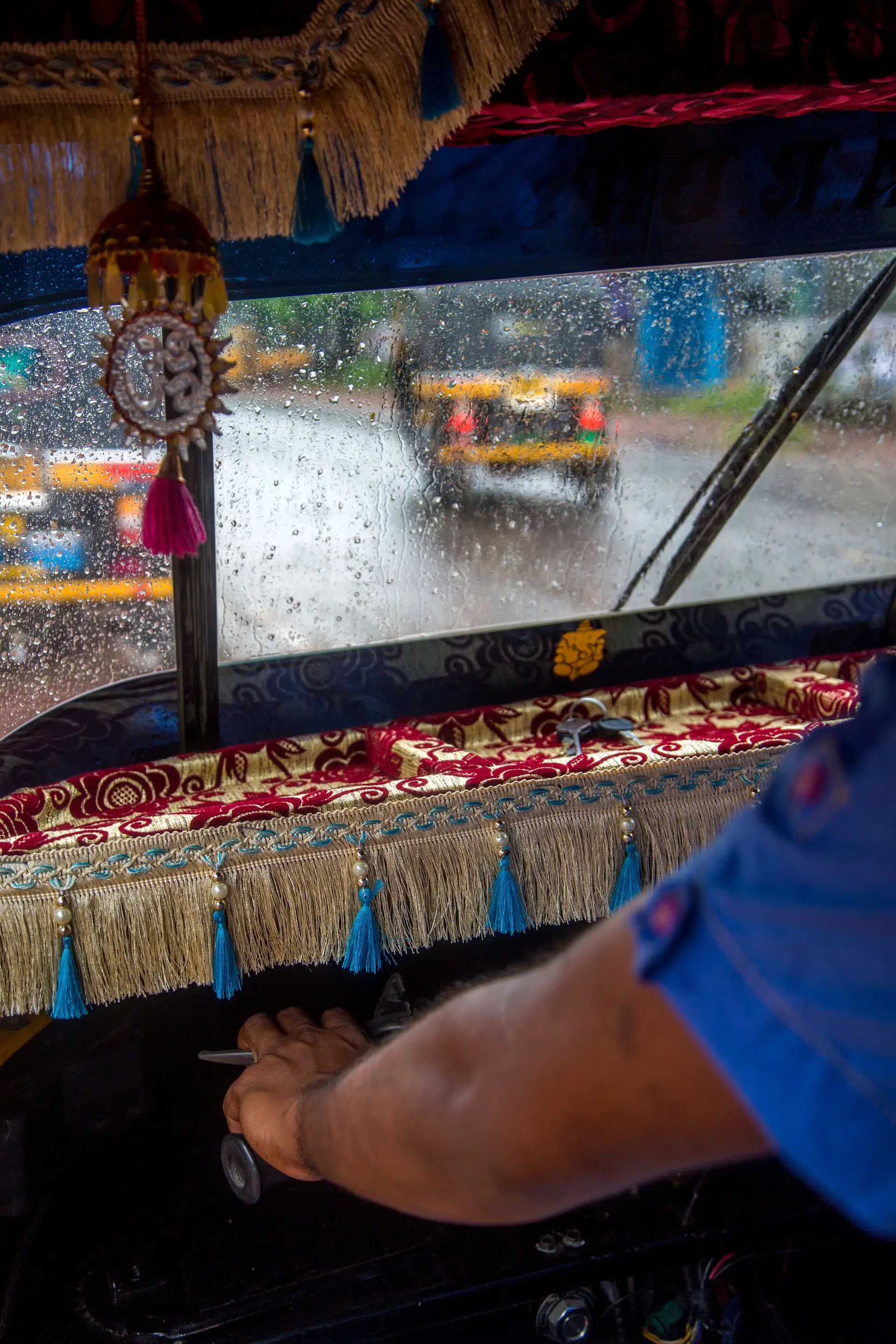 Voyage en Asie – Tuk-tuk décoré en Inde sous la pluie, symbole de voyage authentique pendant la mousson