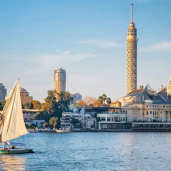 Felouque naviguant sur le Nil devant la Tour du Caire au coucher du soleil