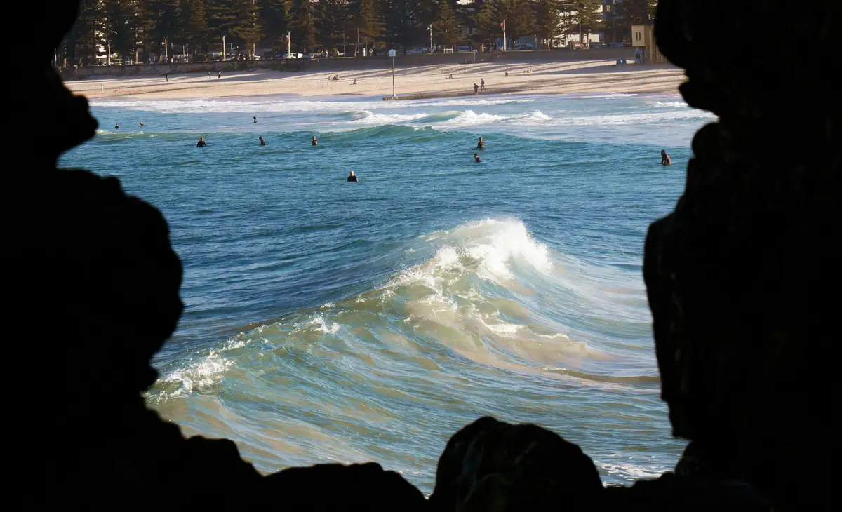 Vue de Manly Beach à Sydney depuis une grotte rocheuse