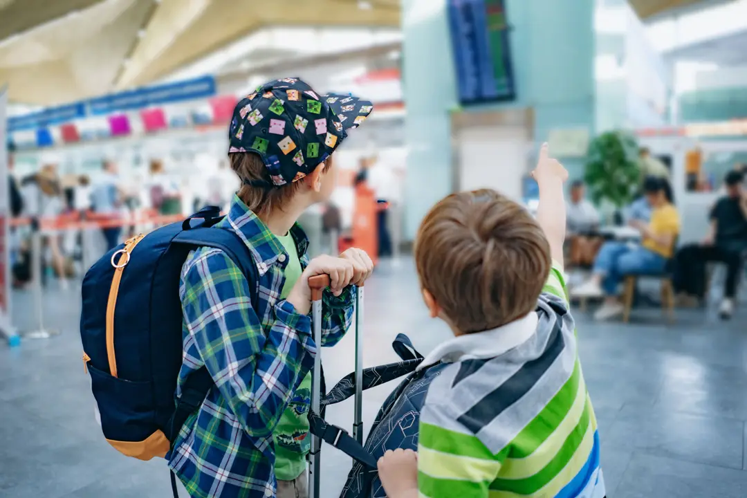 european-siblings-boys-with-backpack-checking-flig-2025-03-09-20-24-38-utc (1).jpg